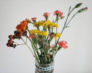 A vibrant floral bouquet featuring assorted blossoms in a clear vase, perfect for lively decor.