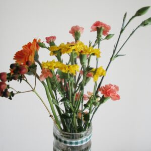A vibrant floral bouquet featuring assorted blossoms in a clear vase, perfect for lively decor.